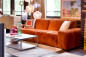 Preview: Bodentiefes Loungesofa Akranes in orangem Chenillebezug. Erhältlich im Möbelhaus Die Wäscherei - Das Möbelhaus in Hamburg.